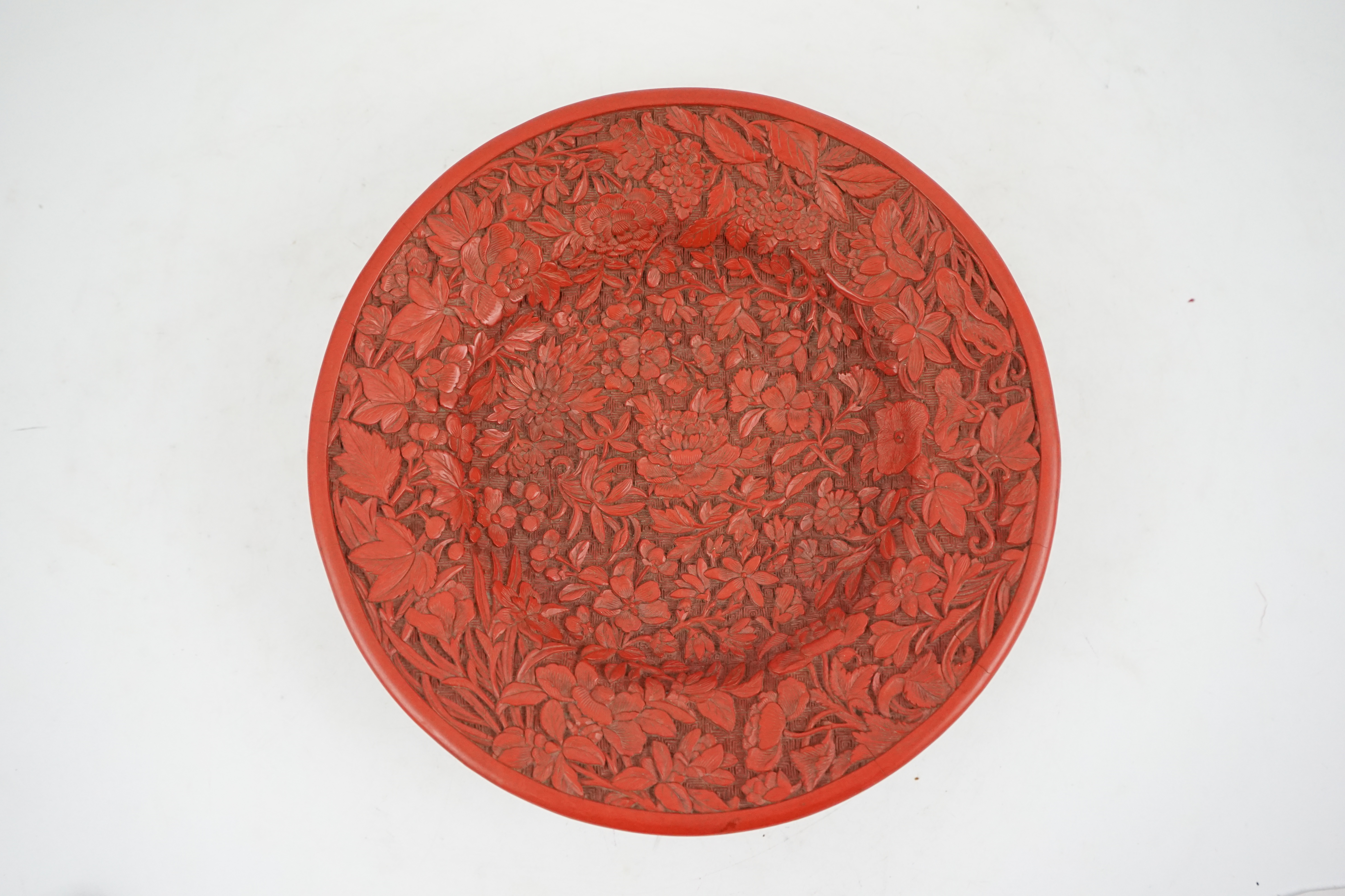 An unusual Chinese cinnabar lacquer ‘thousand flower’ footed dish, 18th/19th century